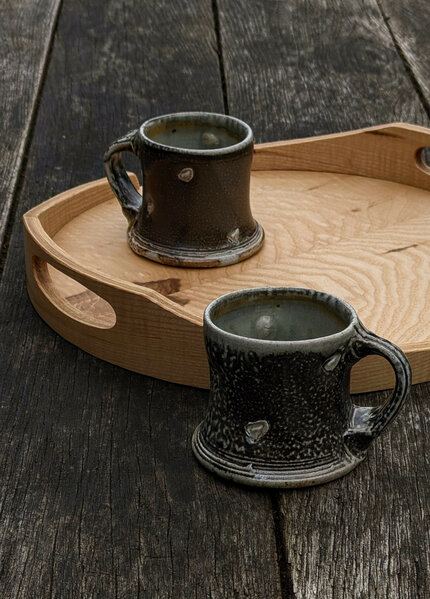 Wood-fired salt-glazed stoneware mugs by Jeremy Steward, ripple ash round tray by Ben Casson
